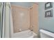 This bathroom features a tiled shower with a curtain and a blue accent wall at 1742 Oakwood Estates Dr, Plant City, FL 33563