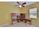 Bedroom featuring a ceiling fan and a built in desk with overhead cabinets at 1742 Oakwood Estates Dr, Plant City, FL 33563