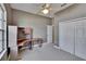 Bedroom features a ceiling fan, built-in desk, and closet with bi-fold doors at 1742 Oakwood Estates Dr, Plant City, FL 33563