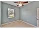 This bedroom has light-colored walls, carpet, a window for natural light, and a ceiling fan at 1742 Oakwood Estates Dr, Plant City, FL 33563