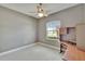 Neutral toned room featuring a ceiling fan and a built in desk with outside views at 1742 Oakwood Estates Dr, Plant City, FL 33563
