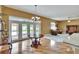 Dining area has a modern chandelier, table, and French doors to outside patio at 1742 Oakwood Estates Dr, Plant City, FL 33563
