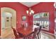 Beautiful dining room with a large window, hardwood floors, a chandelier, and a wooden table at 1742 Oakwood Estates Dr, Plant City, FL 33563
