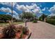Entrance to Oakwood Estates featuring manicured landscaping and brick paver roads at 1742 Oakwood Estates Dr, Plant City, FL 33563