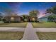 Charming home with a well-manicured lawn and a brick walkway leading to the front door at 1742 Oakwood Estates Dr, Plant City, FL 33563