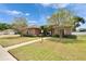 Exterior shot of a well-manicured front yard with a brick walkway leading to the home's entrance at 1742 Oakwood Estates Dr, Plant City, FL 33563