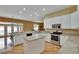 Eat-in kitchen with white cabinetry, granite countertops, stainless appliances, and breakfast bar at 1742 Oakwood Estates Dr, Plant City, FL 33563