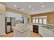 Kitchen featuring white cabinets, granite countertops, stainless refrigerator, and open floorplan at 1742 Oakwood Estates Dr, Plant City, FL 33563