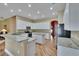 Bright kitchen features granite countertops, white cabinets, an island, and stainless steel appliances at 1742 Oakwood Estates Dr, Plant City, FL 33563