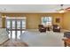 Bright living room with cozy seating, ceiling fan, and access to an outdoor patio at 1742 Oakwood Estates Dr, Plant City, FL 33563