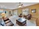 Bright living room with cozy seating, ceiling fan, and access to an outdoor patio at 1742 Oakwood Estates Dr, Plant City, FL 33563