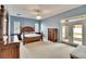 Spacious main bedroom with a ceiling fan and light blue walls with an exterior door at 1742 Oakwood Estates Dr, Plant City, FL 33563