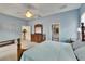 Spacious main bedroom with light blue walls with the Primary bath and kitchen visible at 1742 Oakwood Estates Dr, Plant City, FL 33563