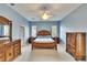 Spacious main bedroom with a ceiling fan and light blue walls with a nice set of furniture at 1742 Oakwood Estates Dr, Plant City, FL 33563