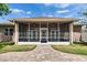 Screened-in patio with brick pavers offers a relaxing outdoor living space with ceiling fans at 1742 Oakwood Estates Dr, Plant City, FL 33563