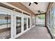 This is a covered patio with brick floor and screen. Natural light is prominent at 1742 Oakwood Estates Dr, Plant City, FL 33563
