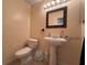 Cozy powder room with pedestal sink and decorated mirror at 206 Soldier Ct, Seffner, FL 33584