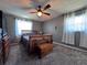 Charming bedroom featuring a wooden bed frame, ceiling fan, and carpeted floors at 206 Soldier Ct, Seffner, FL 33584