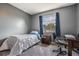 Bedroom with desk area, carpet flooring, and window with blue curtains at 206 Soldier Ct, Seffner, FL 33584