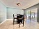 The dining area has tiled floors, a neutral color palette and glass doors to the lanai at 206 Soldier Ct, Seffner, FL 33584
