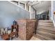 View of the entryway with tiled floors, stairs to the living room, and decorative brick accent wall at 206 Soldier Ct, Seffner, FL 33584