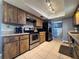 View of kitchen with stainless appliances, tiled backsplash, and wood-look cabinetry at 206 Soldier Ct, Seffner, FL 33584