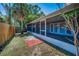 Backyard view of covered lanai with tile floor and screened windows from the yard at 2200 Horan S Way, Gulfport, FL 33707