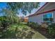 Well-maintained backyard featuring green grass, landscaping, wooden fence and view of the home's exterior at 2200 Horan S Way, Gulfport, FL 33707