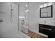 Updated bathroom with stylish vanity, modern lighting, and a frameless glass shower with unique tile at 2200 Horan S Way, Gulfport, FL 33707