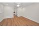 Neutral bedroom featuring wood-look floors, light walls, and ample space with access to hallway at 2200 Horan S Way, Gulfport, FL 33707