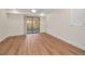Bright bedroom with wood-look flooring, neutral walls, and sliding glass door to a patio at 2200 Horan S Way, Gulfport, FL 33707