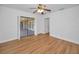 Bright bedroom with wood-look floors and access to an enclosed patio through sliding glass doors at 2200 Horan S Way, Gulfport, FL 33707