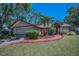Charming single-story home with a well-maintained lawn and tropical landscaping at 2200 Horan S Way, Gulfport, FL 33707