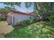 Exterior side view of the house showing grass, landscaping, and a wood fence at 2200 Horan S Way, Gulfport, FL 33707