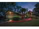 Charming home featuring a colorful front walkway, well-kept landscaping, and attached garage at 2200 Horan S Way, Gulfport, FL 33707