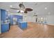 Spacious open-plan kitchen with an island, blue cabinets, and stainless steel appliances flowing into the living area at 2200 Horan S Way, Gulfport, FL 33707