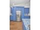 Kitchen with stainless steel refrigerator, ample storage, and bright blue custom cabinets at 2200 Horan S Way, Gulfport, FL 33707