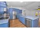 Spacious kitchen with stainless steel appliances, bright blue cabinets, and center island at 2200 Horan S Way, Gulfport, FL 33707