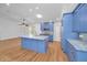 Updated kitchen featuring blue cabinetry, granite countertops, a central island, and stainless steel appliances at 2200 Horan S Way, Gulfport, FL 33707