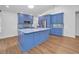 Well-lit kitchen with modern appliances, an island, and bright blue custom cabinets at 2200 Horan S Way, Gulfport, FL 33707
