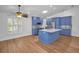 Well-lit kitchen with modern appliances, an island, and bright blue custom cabinets at 2200 Horan S Way, Gulfport, FL 33707