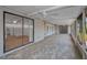 Large covered lanai with tile flooring, sliding doors, screen windows, and bright natural lighting at 2200 Horan S Way, Gulfport, FL 33707