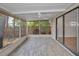 Covered lanai featuring decorative tile flooring, screened windows, and fan with backyard view at 2200 Horan S Way, Gulfport, FL 33707
