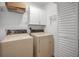 Functional laundry room with washer, dryer, and overhead storage at 2200 Horan S Way, Gulfport, FL 33707