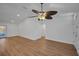 Open living room with wood-look floors, light walls, modern fan, and an entrance door at 2200 Horan S Way, Gulfport, FL 33707