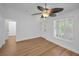 Welcoming living room featuring wood-look floors, neutral walls, and a large window with plantation shutters at 2200 Horan S Way, Gulfport, FL 33707