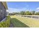 Spacious backyard with lush grass, a canal with a railing, and the side of the home at 2419 Richmond Greens Ct, Sun City Center, FL 33573