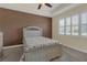 Comfortable bedroom featuring neutral decor, a plush carpet, and natural light from the window at 2419 Richmond Greens Ct, Sun City Center, FL 33573