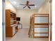 Spacious bedroom with bunk beds, a study desk, and tile flooring for a clean and functional space at 2419 Richmond Greens Ct, Sun City Center, FL 33573