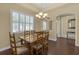 Bright dining room featuring a glass table, plantation shutters and neutral paint at 2419 Richmond Greens Ct, Sun City Center, FL 33573